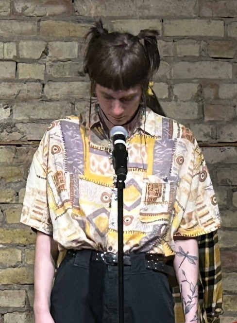 Tommy Fowler stands before Veronica Kruschel with his head down before the duo beginning begin ther group piece.